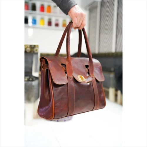 Elegant Brown Leather Handbag with Gold Accent
